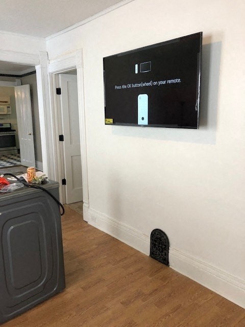 a television hangs on the wall in a living room