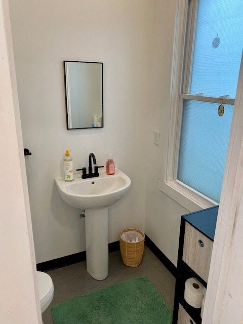 a bathroom with a sink a mirror and a window
