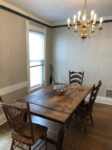 a dining room with a table and chairs and a chandelier