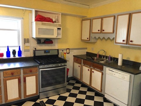 a kitchen with a black and white checkered floor
