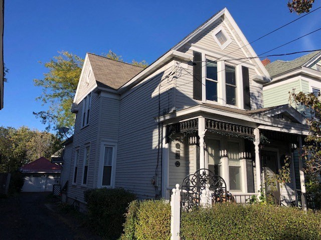 a white house with a black gate