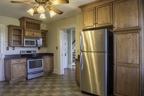 a kitchen with stainless steel appliances and wooden cabinets