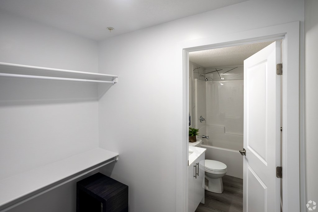 A white bathroom with a toilet and sink.