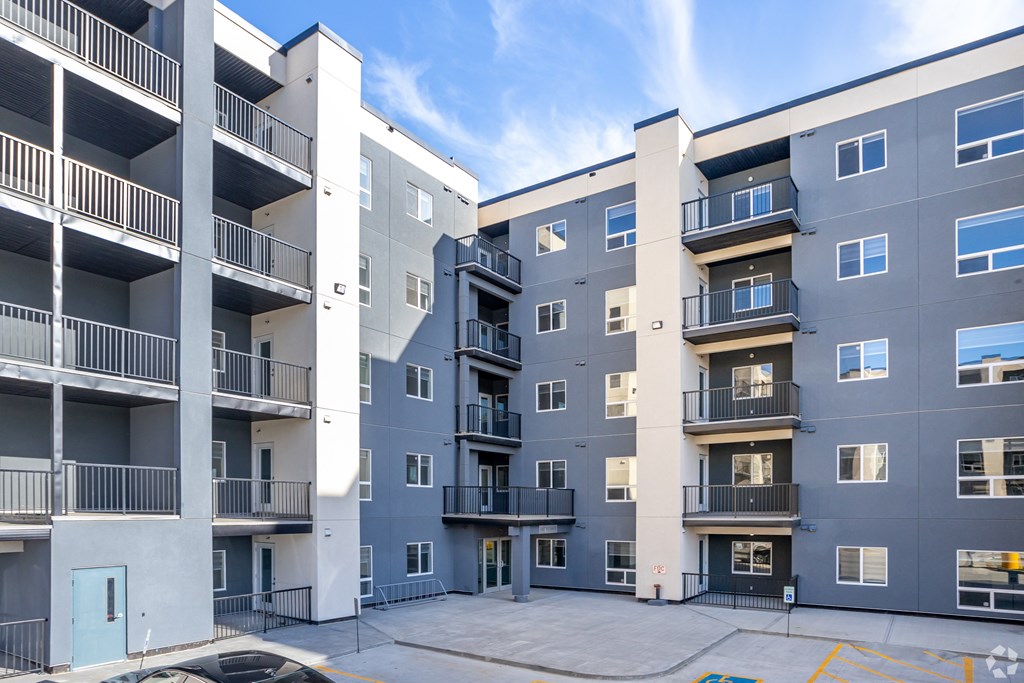 A large apartment complex with multiple balconies and doors.