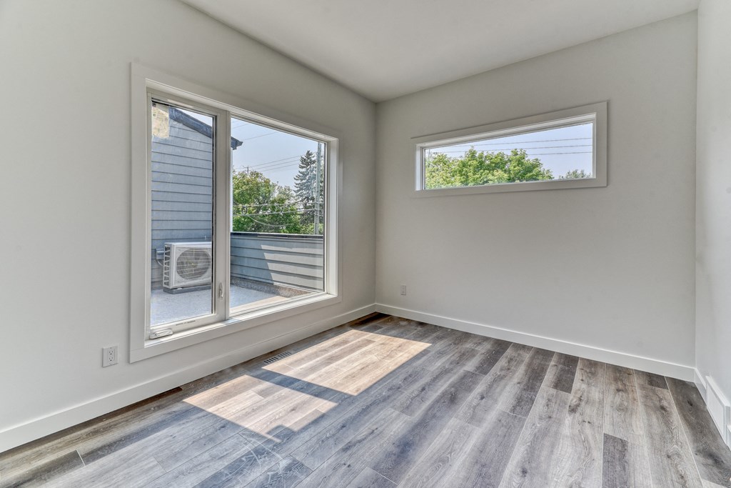 A room with a window and a sliding glass door.