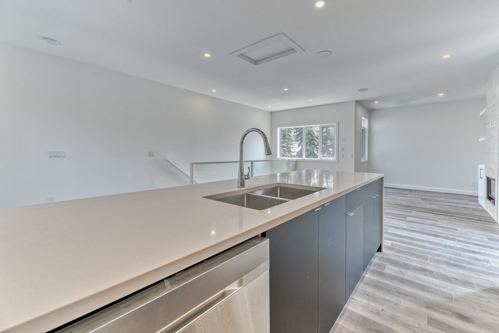 A modern kitchen with a stainless steel sink and countertop.
