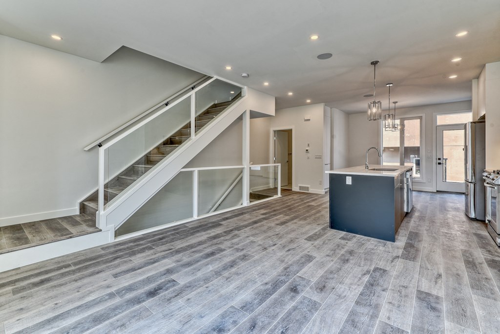 A spacious open floor plan with a staircase leading to the upper level.