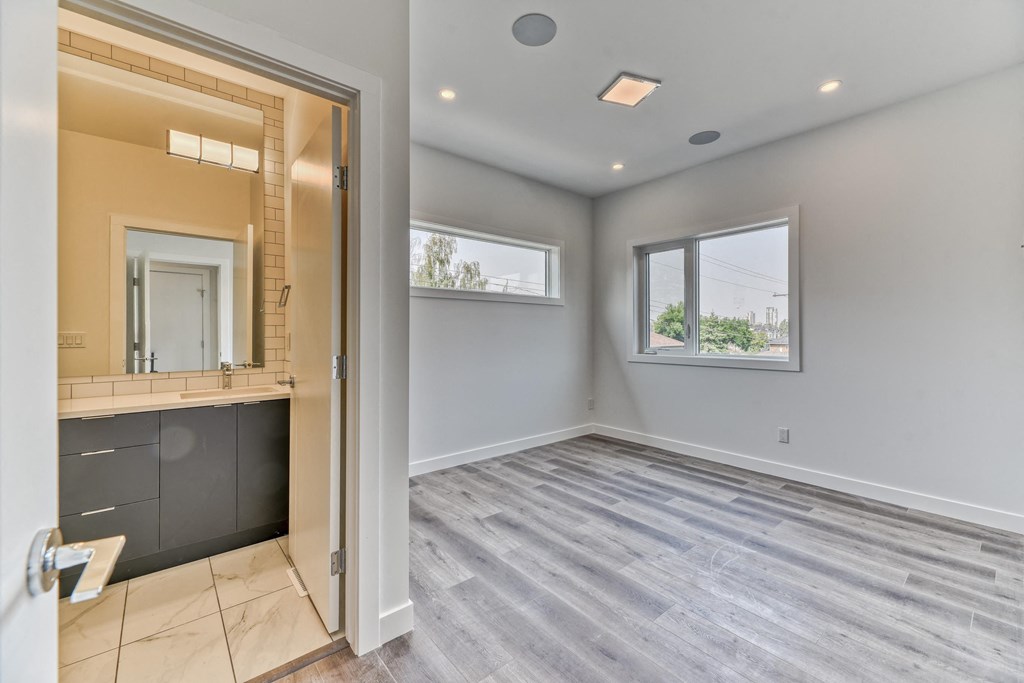 A bathroom with a vanity and a large mirror.