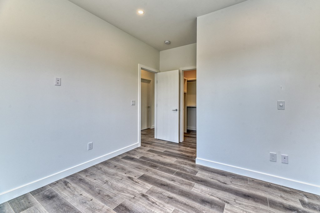 A room with a grey floor and white walls.