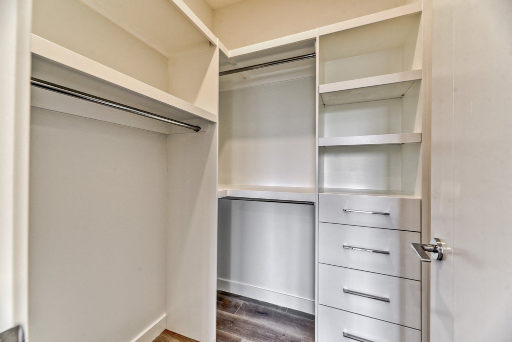 A kitchen pantry with a white cabinet and drawers.