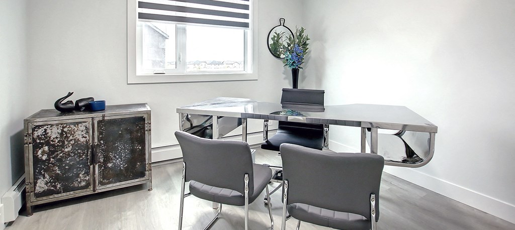 A white room with a table and chairs.