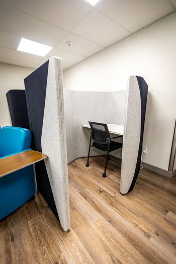 a dividing wall in an office with a table and chairs