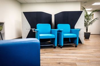 a row of blue chairs in an office