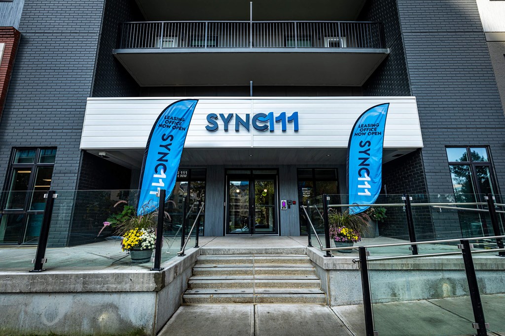 a building with two blue banners in front of it
