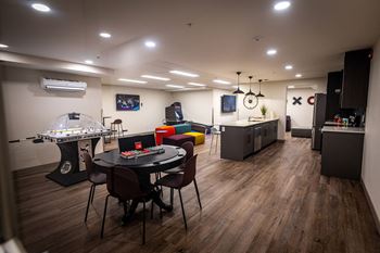 a game room with a table and chairs and a jukebox
