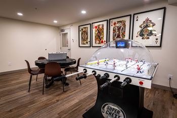 a game room with a foosball table and a ping pong table
