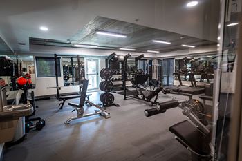 a workout room with weights and other exercise equipment