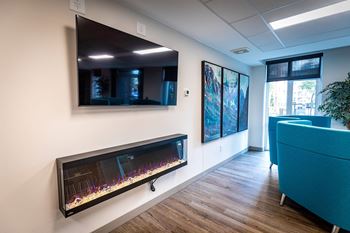 a living room with a fireplace and a tv on the wall