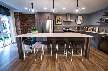 a kitchen with a large island and bar stools
