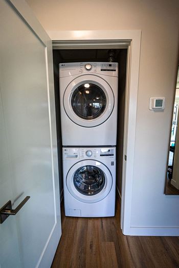 a front loading washer and dryer in a small closet