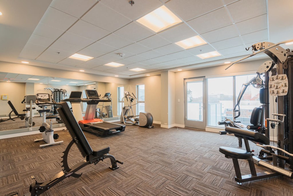 A spacious gym with a variety of equipment including treadmills, weights, and exercise machines.