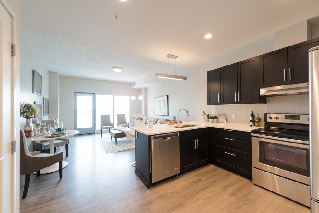 A modern kitchen with a dining table and chairs.