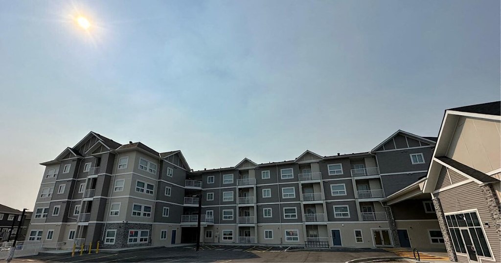 an apartment building with the sun shining over it