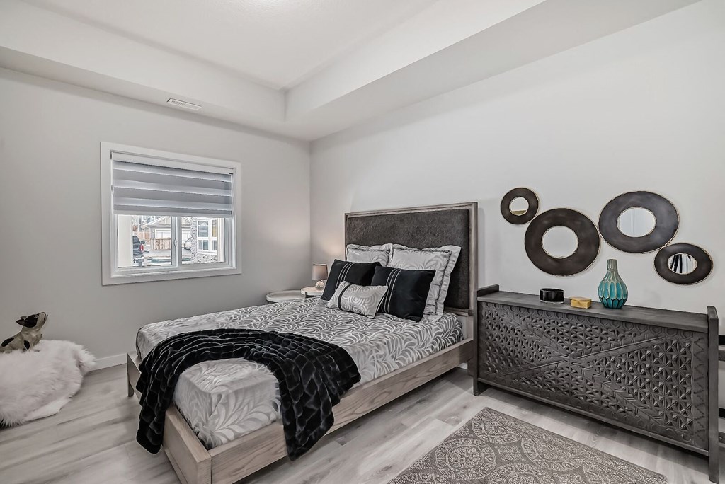 a bedroom with a large bed and a window