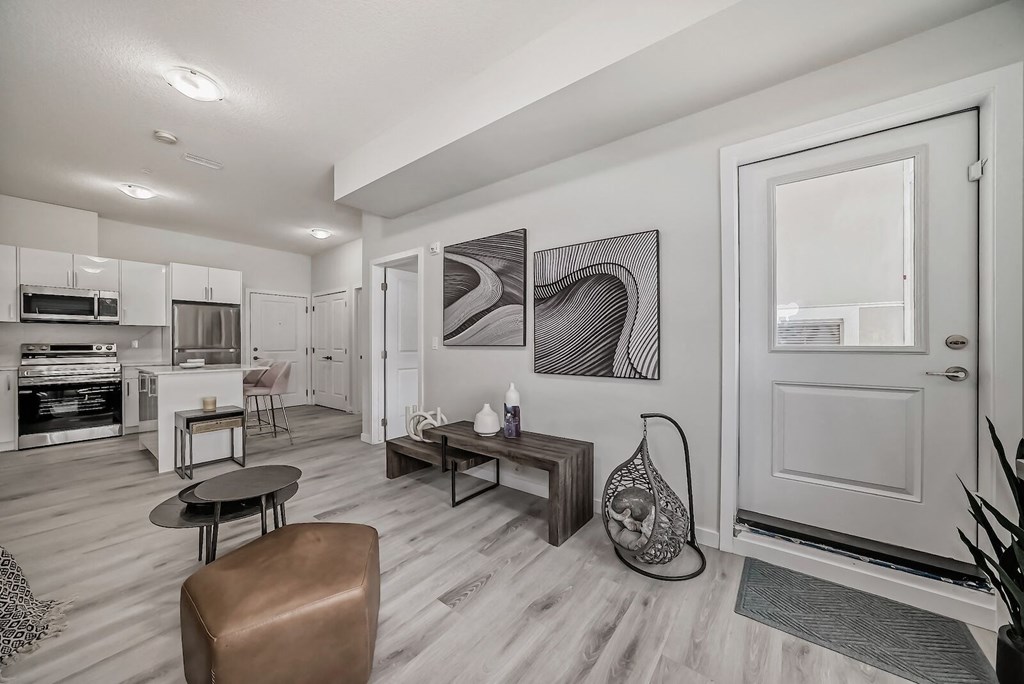 a living room with a door to a kitchen and a dining room