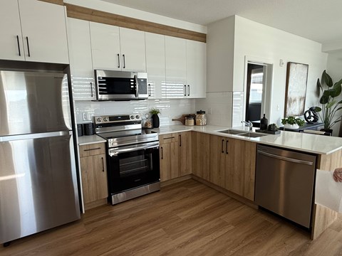 A modern kitchen with wooden cabinets and stainless steel appliances.