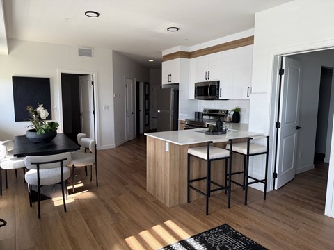 A kitchen with a table and chairs in the middle of the room.