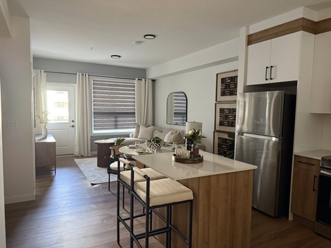 A kitchen with a bar stool and a counter.