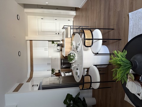 A kitchen with a white countertop and wooden cabinets.
