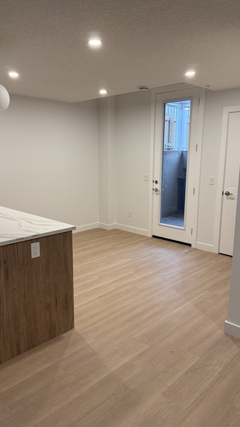 A room with wooden floors and white walls.