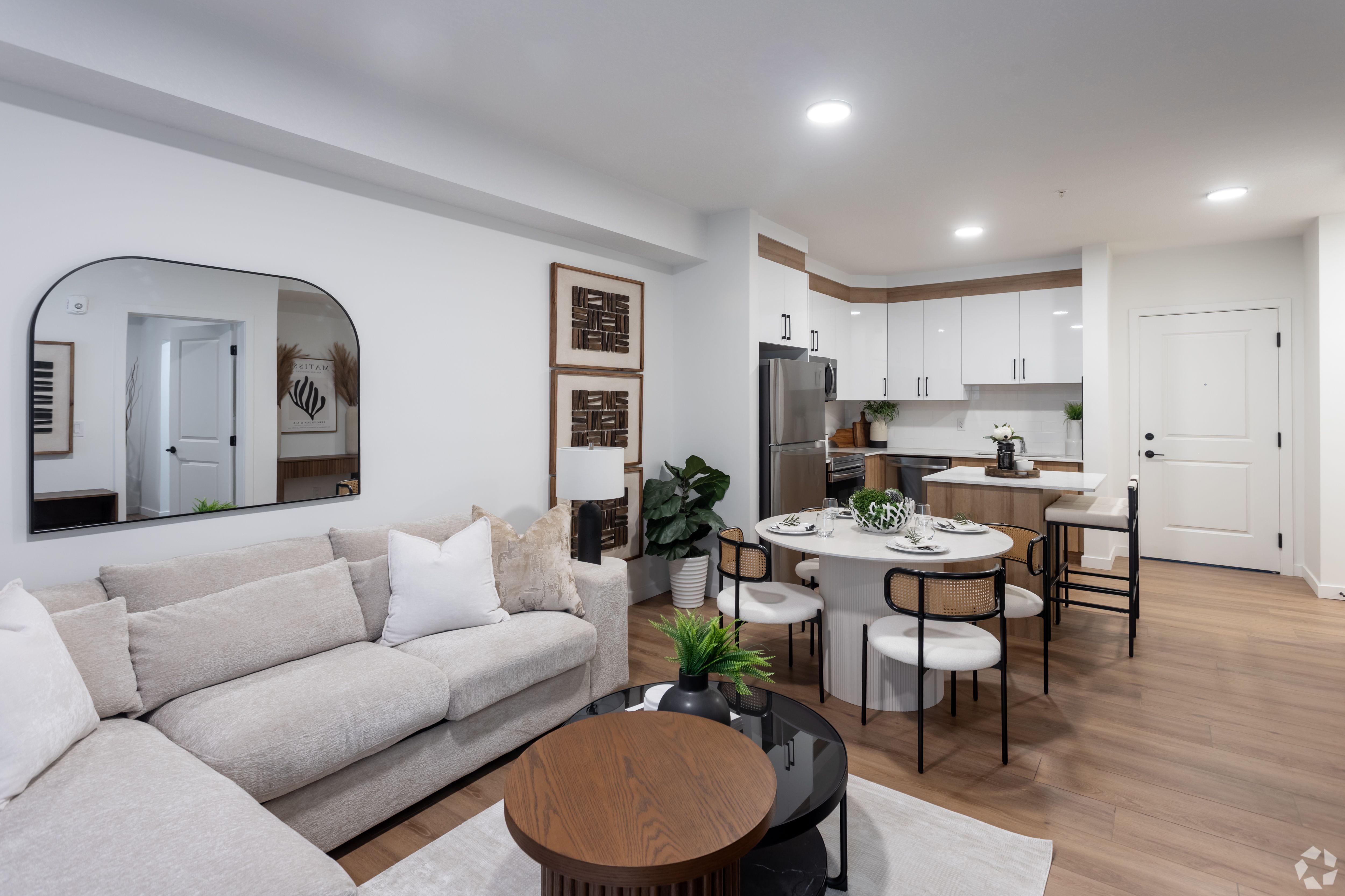 A modern living room with a grey sofa and a wooden coffee table.