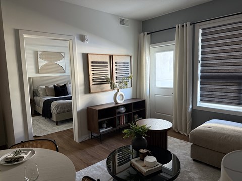 A modern living room with a dining table and a sofa.