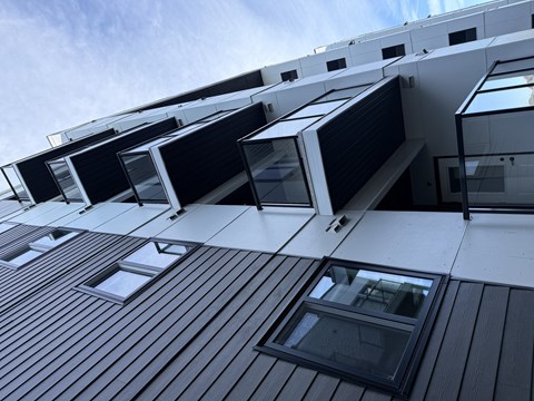 A modern building with black and white exterior and large windows.