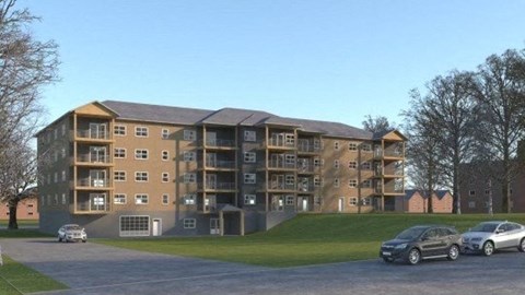 a large apartment building with cars parked in front of it