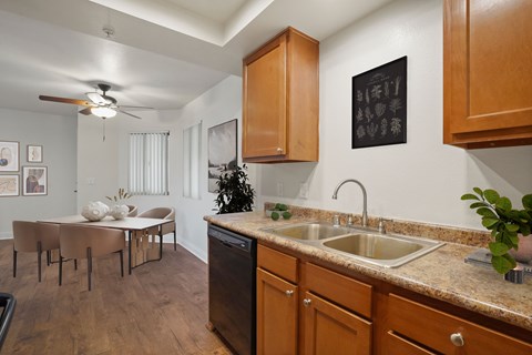 A kitchen with a table and chairs in the middle of the room.