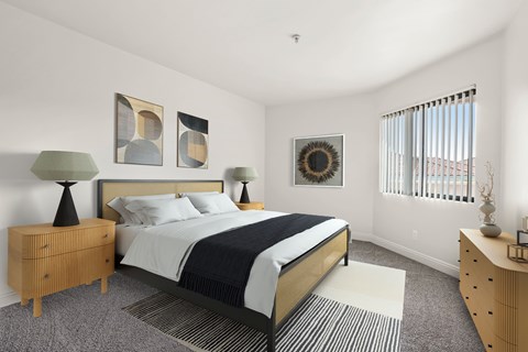 A bedroom with a bed, nightstand, and lamp.
