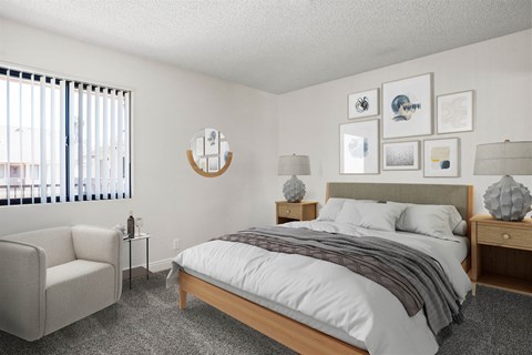 A bedroom with a bed, nightstand, chair, and pictures on the wall.