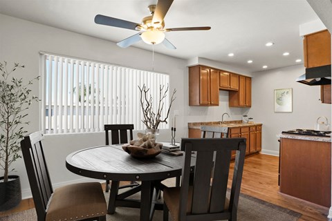 A dining room with a table and chairs.