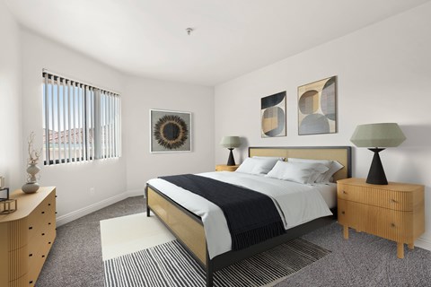 A bedroom with a bed, nightstand, and a dresser.