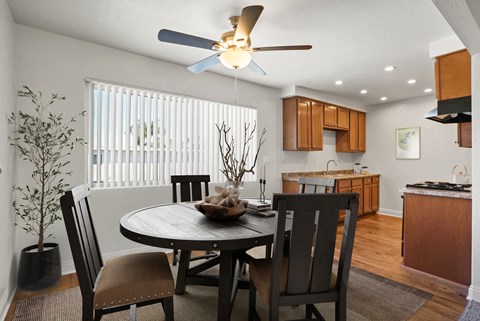 A dining room with a round table and chairs.