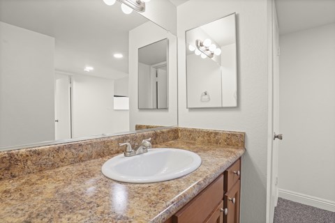 A bathroom with a sink and mirror.