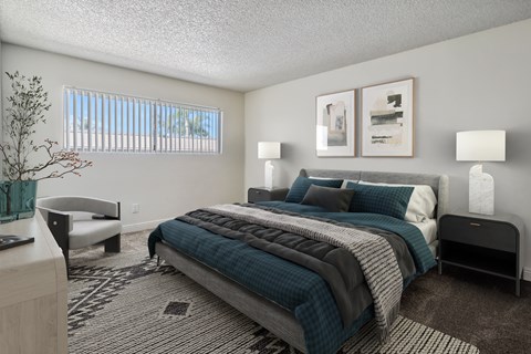 A bedroom with a large bed and a bench.