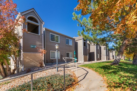 A building with the number 5915 on it is surrounded by trees with orange leaves.