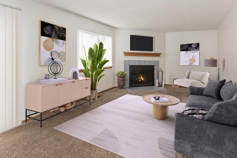 A living room with a fireplace, a grey couch, and a painting on the wall.