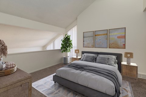 A bedroom with a large bed and a potted plant.