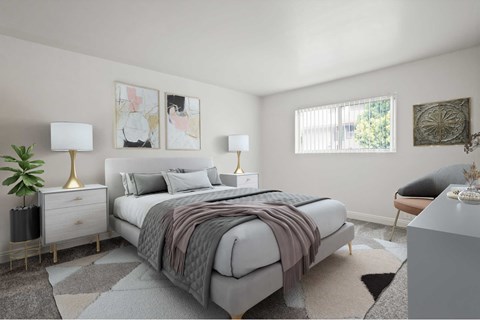 A bedroom with a large bed and a plant on the nightstand.
